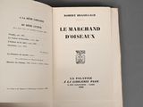 an open book with a picture of a french coat of arms on it