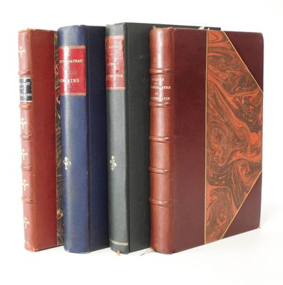 several books are lined up in a row on a white surface