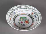 a white bowl with a green and red design on it