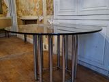 a table with a glass top in the middle of a room