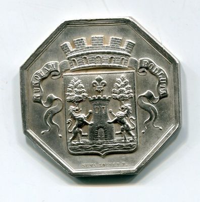a silver coin with a coat of arms on it