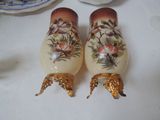 two salt and pepper shakers sitting on a table