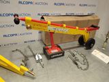 a yellow crane sitting on top of a table next to other tools
