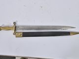 a knife that is laying on top of a piece of paper