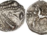 a silver coin with an image of a bird on it