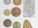 some coins are sitting on top of a white surface next to a bag