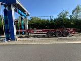 La remorque à plateau est garée devant une station-service