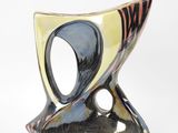 a black and yellow vase with a black and white design on it