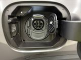 a close up of a car ' s fuel tank with a car plugged into it