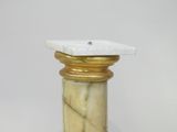 a marble pedestal with a gold base and a white marble top