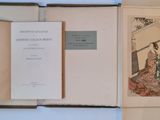 two open books on the table with pictures on them