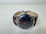 a close up of a wrist watch on a white surface