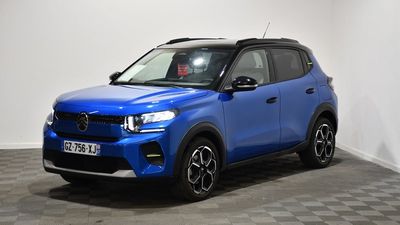 a blue suv parked in a room with a checkered floor
