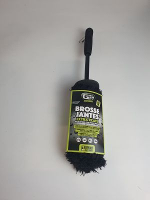 a close up of a black brush on a white surface