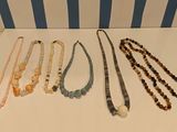 a lot of necklaces on display on a table