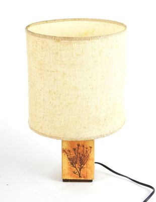 a lamp that is sitting on a table with a lamp shade on it