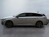 the silver car is parked on the concrete floor in the room