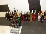 bottles of alcohol are lined up on a counter in front of a tree