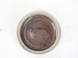a brown bowl on a white surface with a white background
