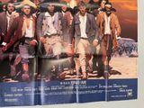 a movie poster of a group of men standing in front of a building