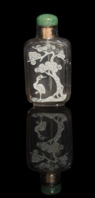 a glass snuff bottle with a picture of a bird on it
