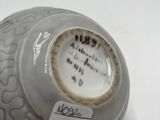 a vase that has a label on it on it