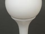a white light bulb that is on a glass stand