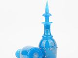 two blue glass vases with a pointed top on a white background