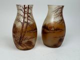 two vases that have been painted with a landscape on them
