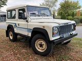 a picture of a white land rover parked on the side of the road