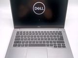 laptop computer with dell logo on screen sitting on white surface