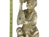 brass figurine of a woman holding a fan and a child