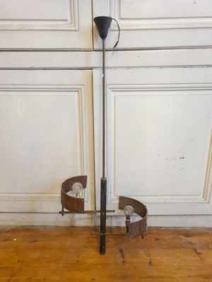 a metal pole with a handle on a wooden floor
