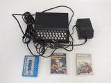 a keyboard, a cassette player, and a video game on a table