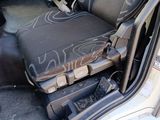 a seat in the back of a car with graffiti on it
