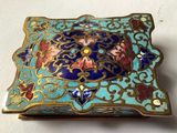 a blue and gold box sitting on a white surface