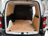 a white van with a wooden floor in the back of it