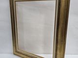 a gold picture frame with a white background