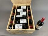 bottles of wine in a wooden box with a bottle of wine in the middle