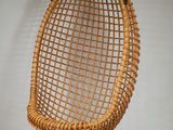 an image of a wicker hanging chair on a white wall