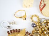 a lot of jewelry on a white surface