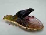 a picture of a brooch of a fish on a leaf