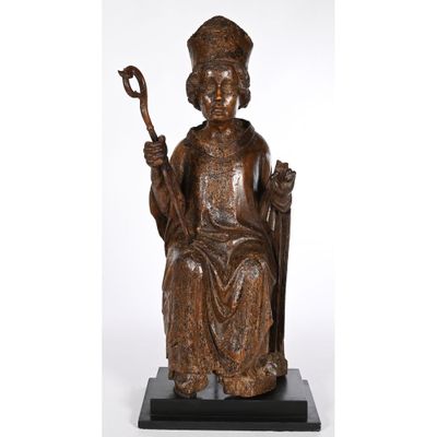 a bronze statue of a man sitting on a chair holding a cane