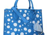 a blue and white polka dot purse with a tassel