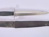 a knife that is laying on a table next to a knife