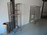 two racks with trays of food on them in a room