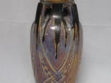 a vase that is sitting on a white surface