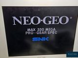 a sign that says neo geo on the back of a computer