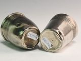 pair of silver salt and pepper shakers on a white surface