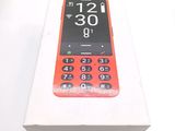 a red cell phone in a white box on a table